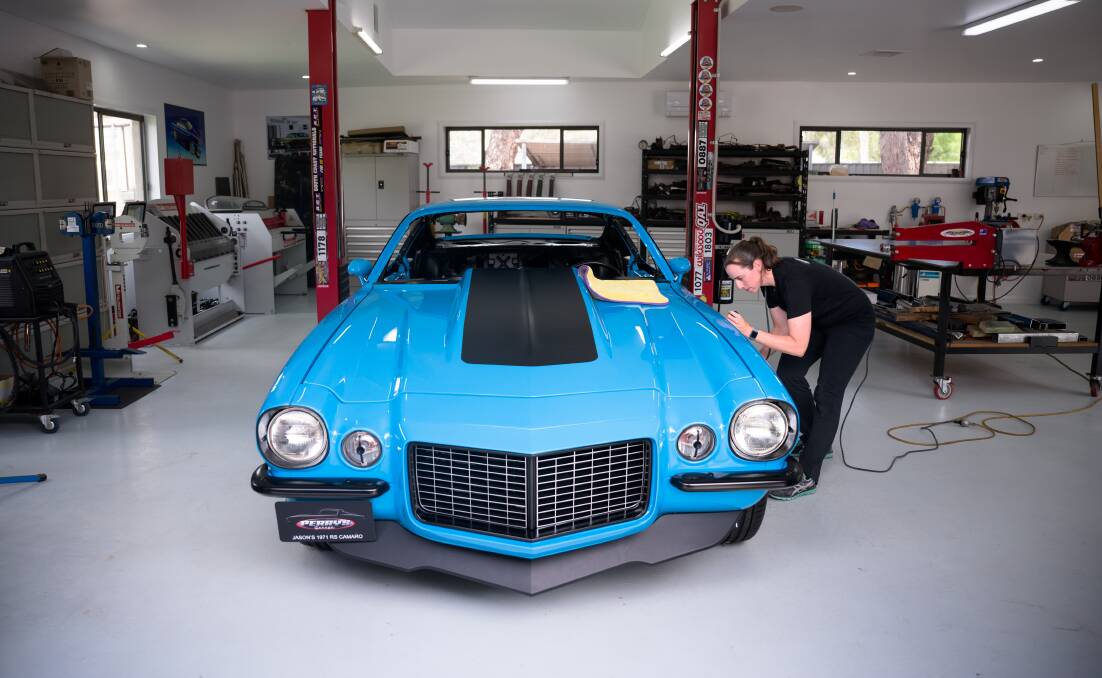 40 hours of polishing, and more ahead. Kylie Perry preapres the Camaro for Summernats display. Picture by Sitthixay Ditthavong