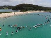Hundreds of paddlers join an event at Narooma's Bar Beach to protest a fishing amnesty within Batemans Marine Park sanctuaries.