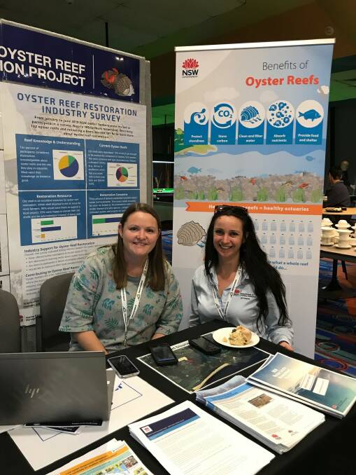 Department of Primary Industry staff handing out survey forms to oyster farmers. Photo Merimbula DPI.