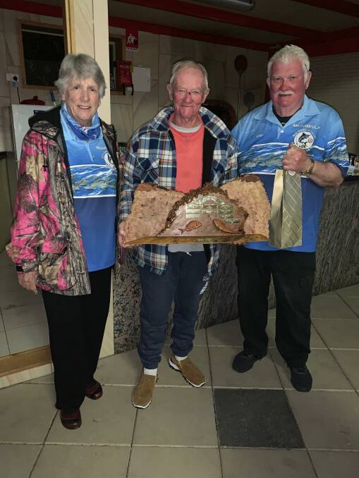 MBGLAC members Merrily Bell and Peter Lawler present the Mex Williams Memorial Trophy to life member Robert Wood after the club's annual trip away to Wallaga Lake.