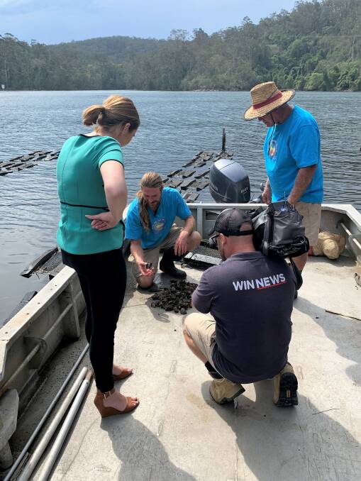 Explaining oyster farming on Wagonga Inlet to the WIN News team this week are Damon and Trevor Fernihough of Out of the Blue Oysters.