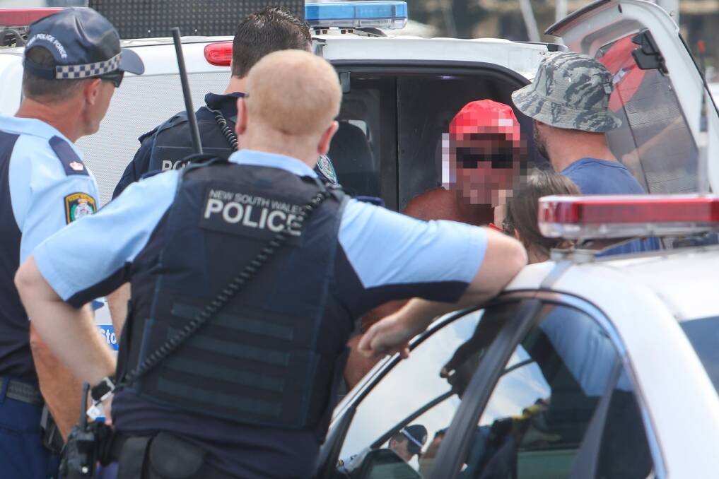 Accused and plain-clothes poilce take a man into custody in Wollongong. Picture: Adam McLean 