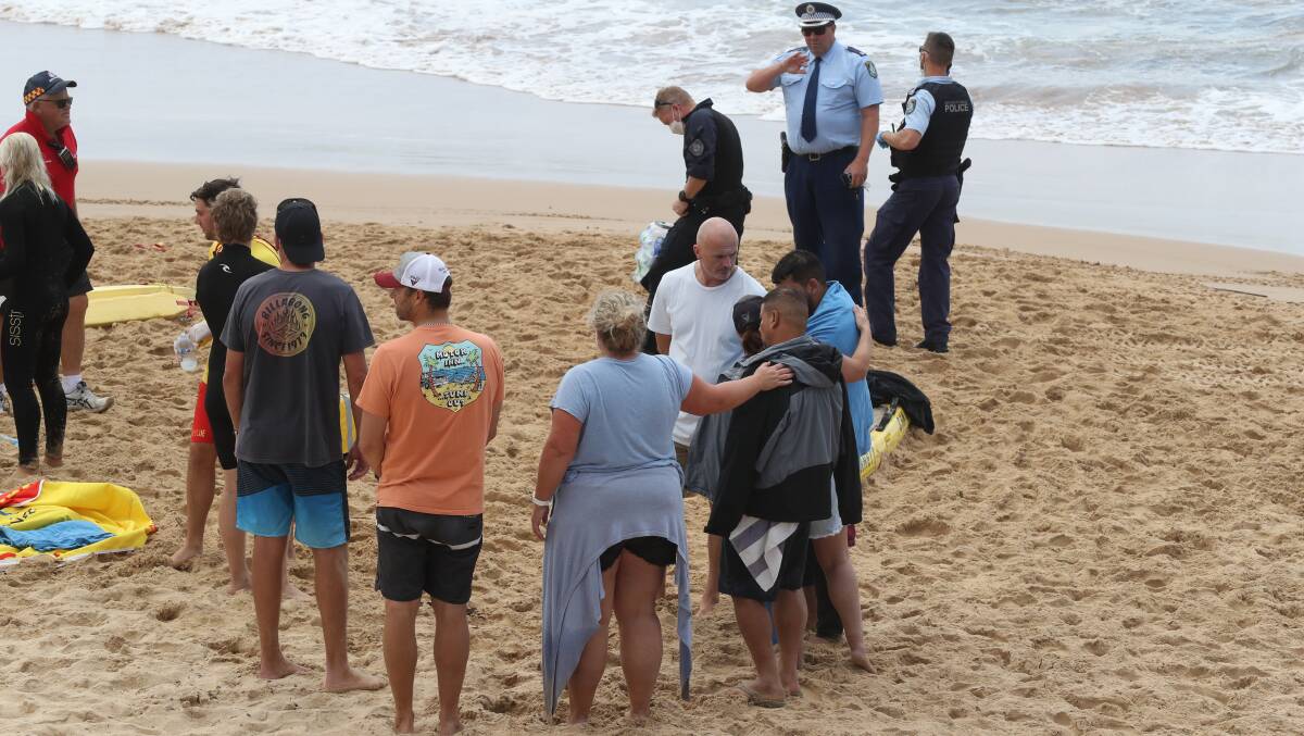 People watch anxiously on Sandon Point Beach. Picture: Rob Peet
