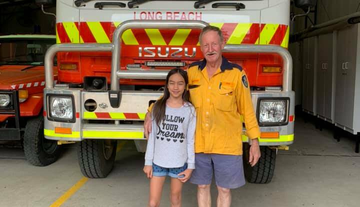 Emerald Smith with a member of the Long Beach brigade of the NSW Rural Fire Service.