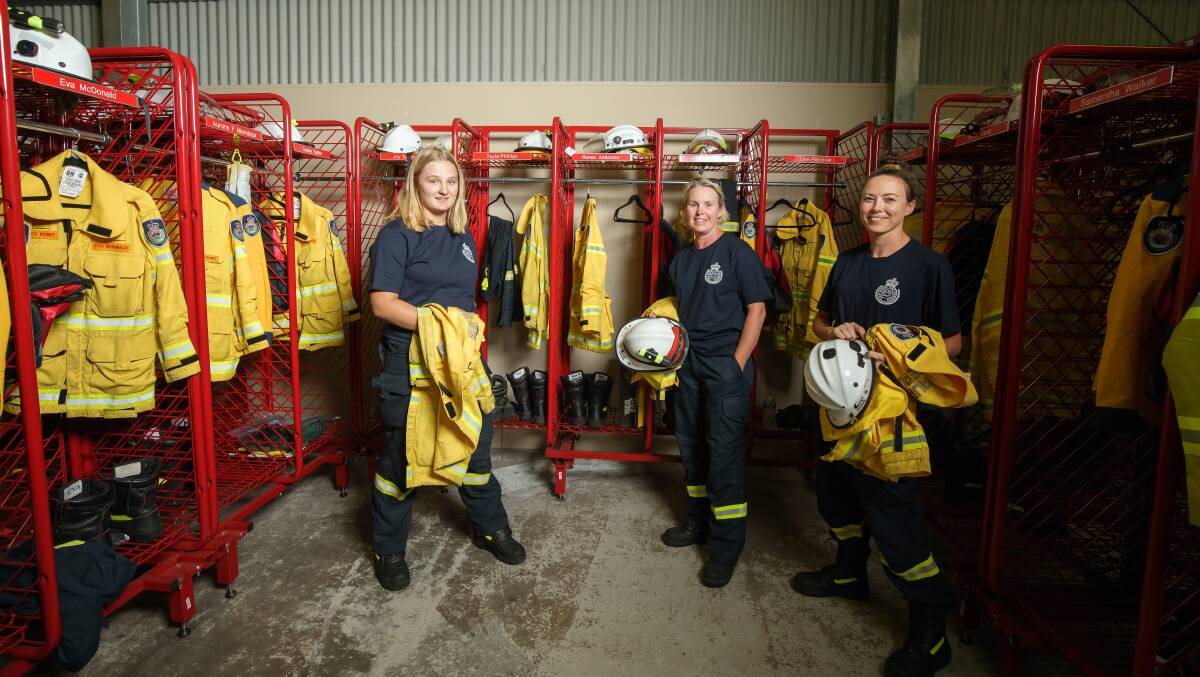 MAKING A DIFFERENCE: Volunteer firefighters Jet Boone, Lise Percival and Samantha Walker gear up in the Bawley Point Rural Fire Brigade's shed. The brigade has 18 female members. Picture: Sitthixay Ditthavong