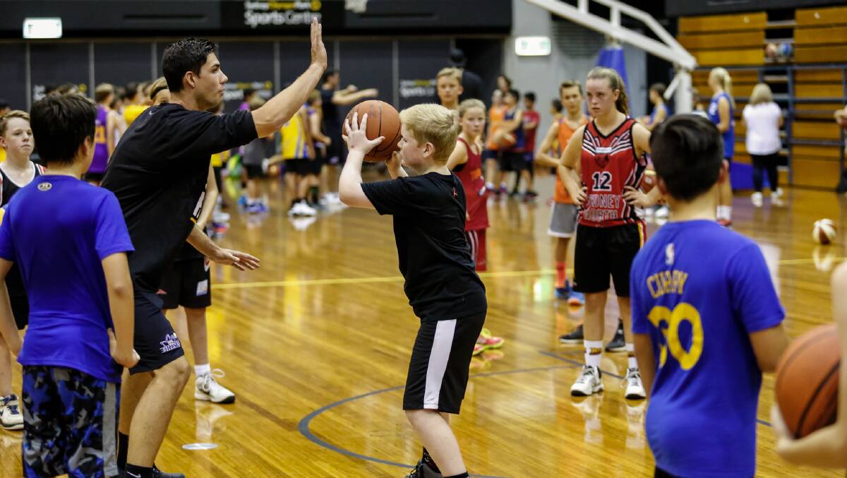 RISING STAR: Darcy Harding helps teach kids at the Sydney Kings Super Clinic held recently.