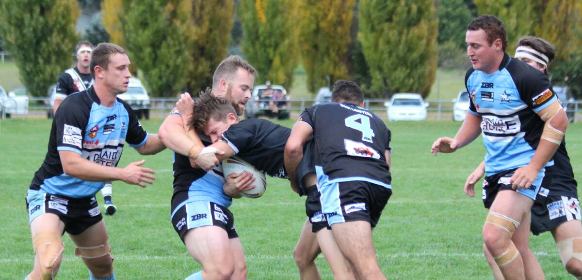 STOPPING A STALLION: The Moruya Sharks' defence work hard to keep out the Cooma Stallions on Saturday. Photo: Monaro Post.