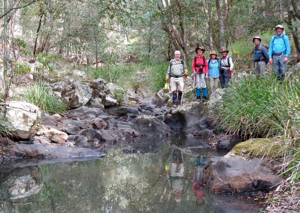 Up the creek: Walk leader Bob Thurbon with Betty Richards, Elaine Edwards, Val Harris, Barry (visitor) and Rob Lees looking at a pool in the mostly dry Mullendaree Creek bed.