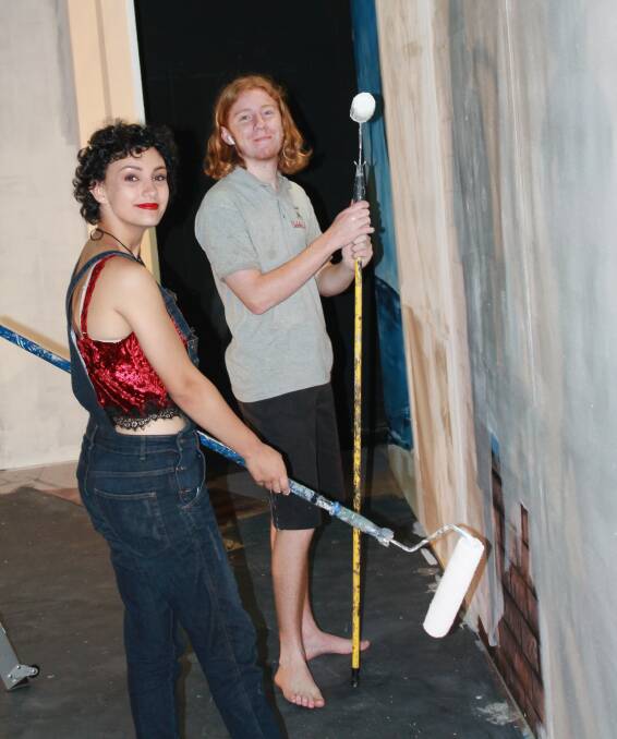 Mia Johnstone and Patrick Eberle painting the flats.
