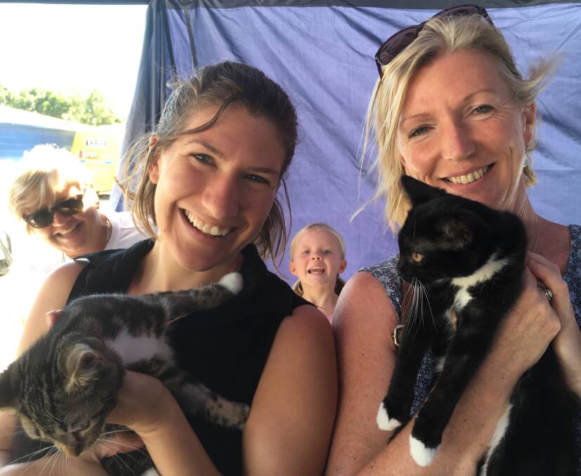 A new home:  Sally Pryor from Central Tilba, and her daughter Hannah, holding the kittens they adopted, Edwin and Elsie, at last Saturday's fabulous Pet Adoption Day in Batemans Bay.  