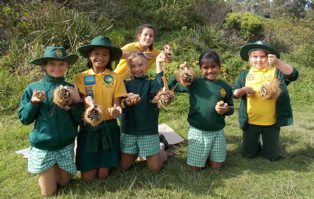 Landcare's next generation: Student representatives from Sunshine Bay Public School show off their big grins and handmade native bee hives at the Eurobodalla Learning Community Environmental Forum at Broulee. 