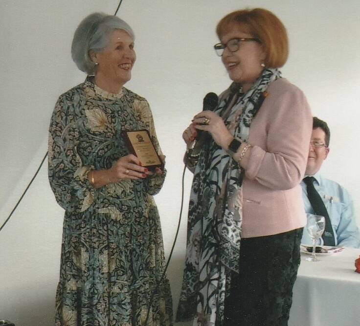 Birthday lunch: Tricia Wheeler receiving a plaque from Pauline James.
