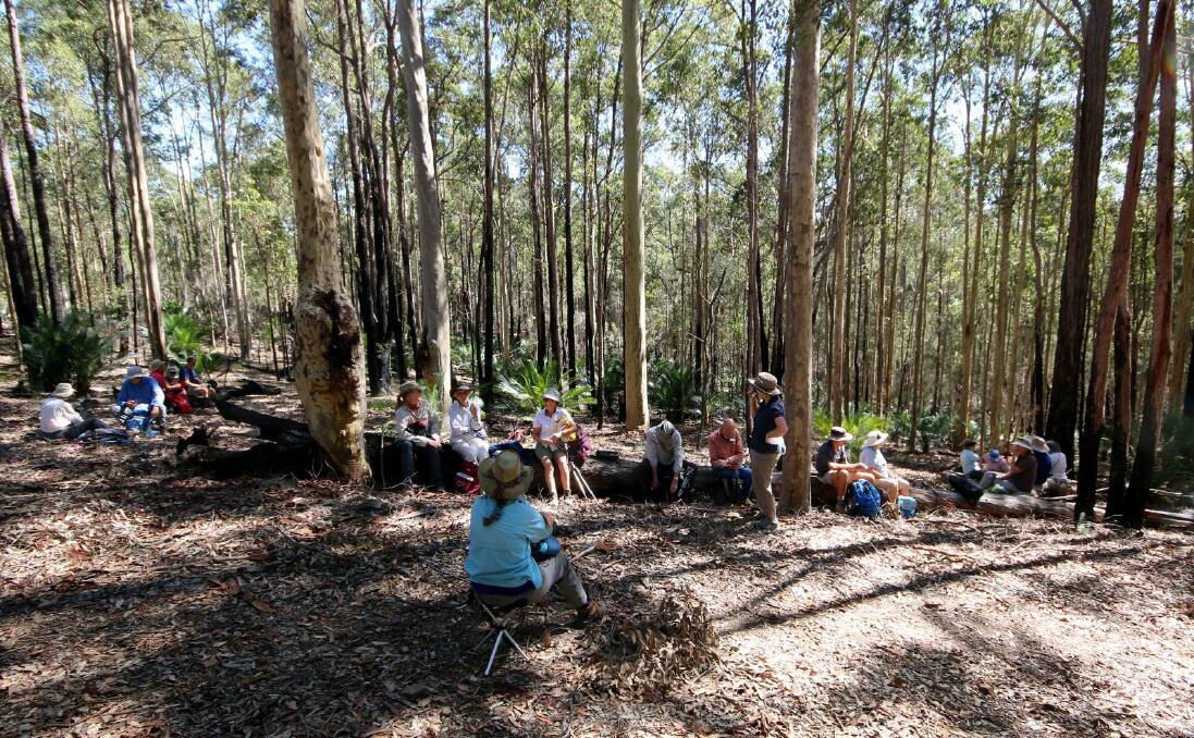 Well-earned break: Batemans Bay bushwalkers enjoy a snack, shaded by the trees at Potato Point. Visitors are welcome on club walks.