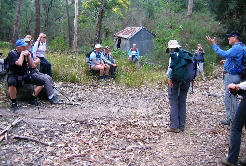 Retired geologist Rob Lees explains the formation of silica and early mining of the mineral in Narrawallee Nature Reserve.
