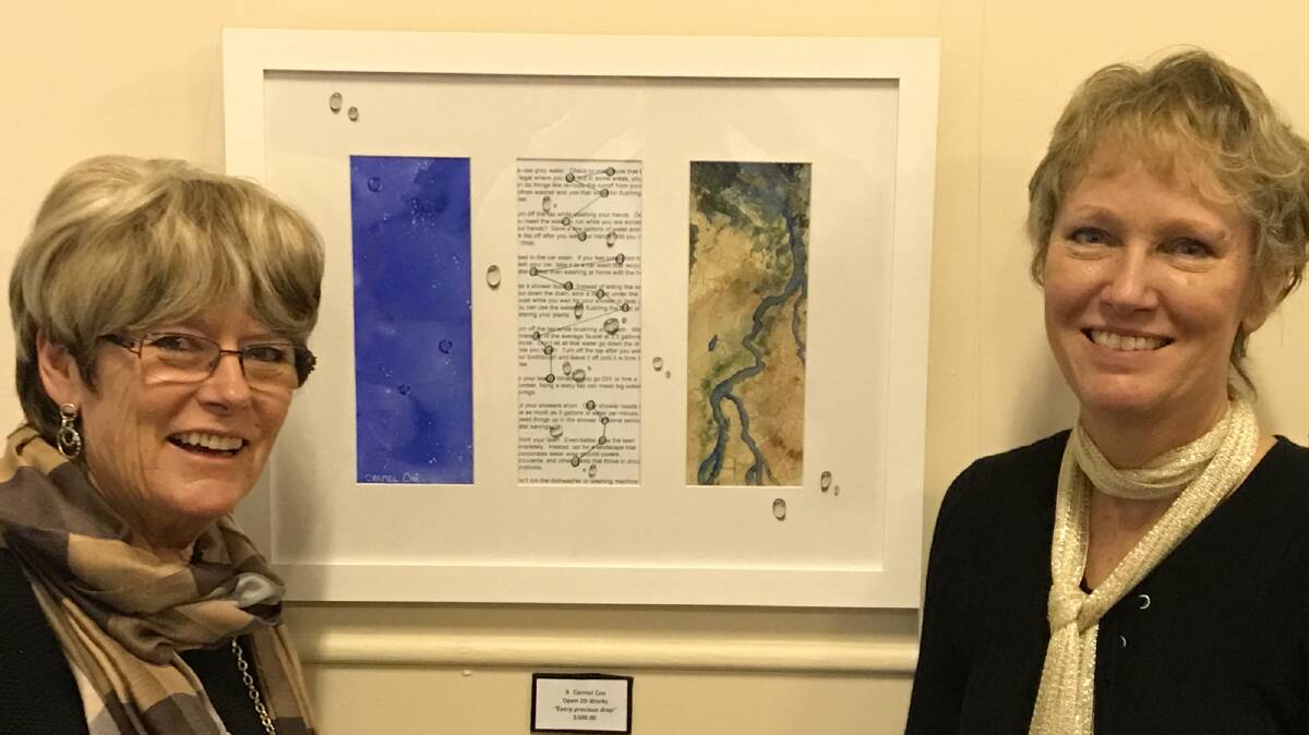 Adrienne Conway and Carmel Cox with Carmel’s winning painting. 