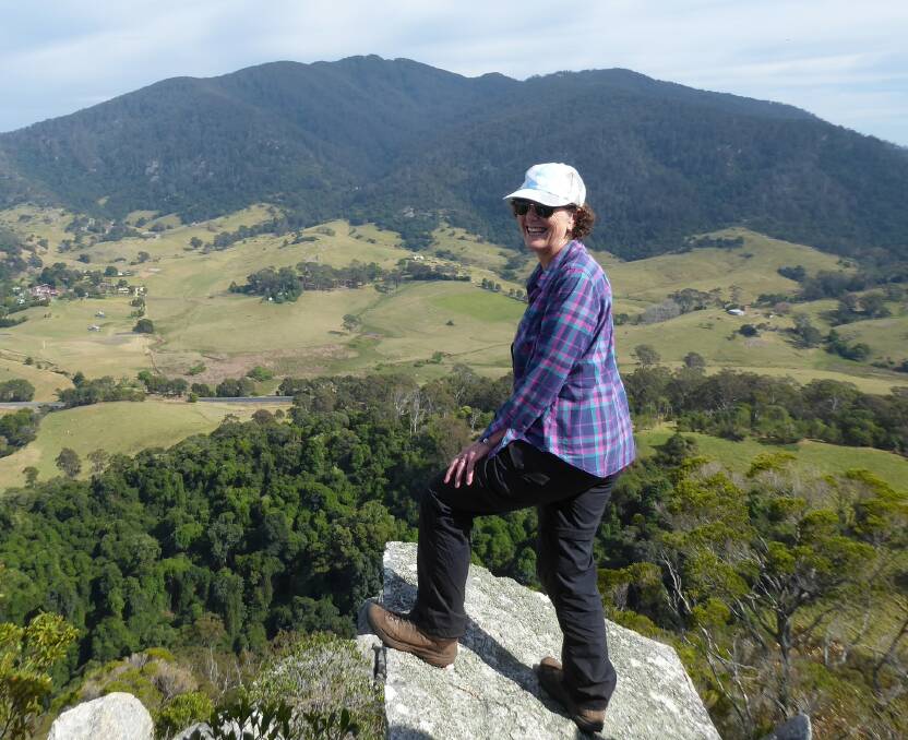 On top of the world: Lin Barnes takes a breath and admires views from the top of Little Dromedary Mountain after a steep climb to the summit.