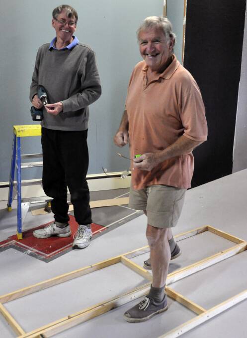 Hard at work: Geoff Philpott and Eric Haslam build the set for the Bay Theatre Players production  'A Murder is Announced'.