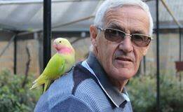 Who's a pretty boy?: Member Martin Daniels with a new friend (a princess parrot) during the club's visit to "On The Perch" bird park at Tathra last month. 
