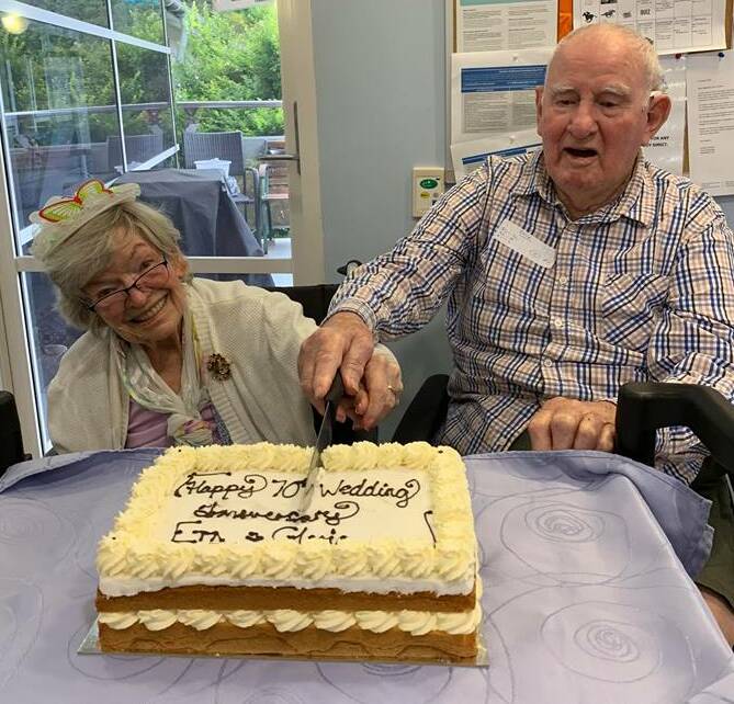 Fashionista: Ern Booth and his beautiful bride of 70 years, Gloria, cutting their cake at a celebration in the Bay recently.