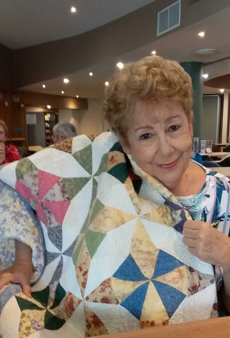 Fashionista: Judy Stewart, who lost almost everything in the fires, is wrapped in love with a patchwork quilt donated through the group "Healing Hands".