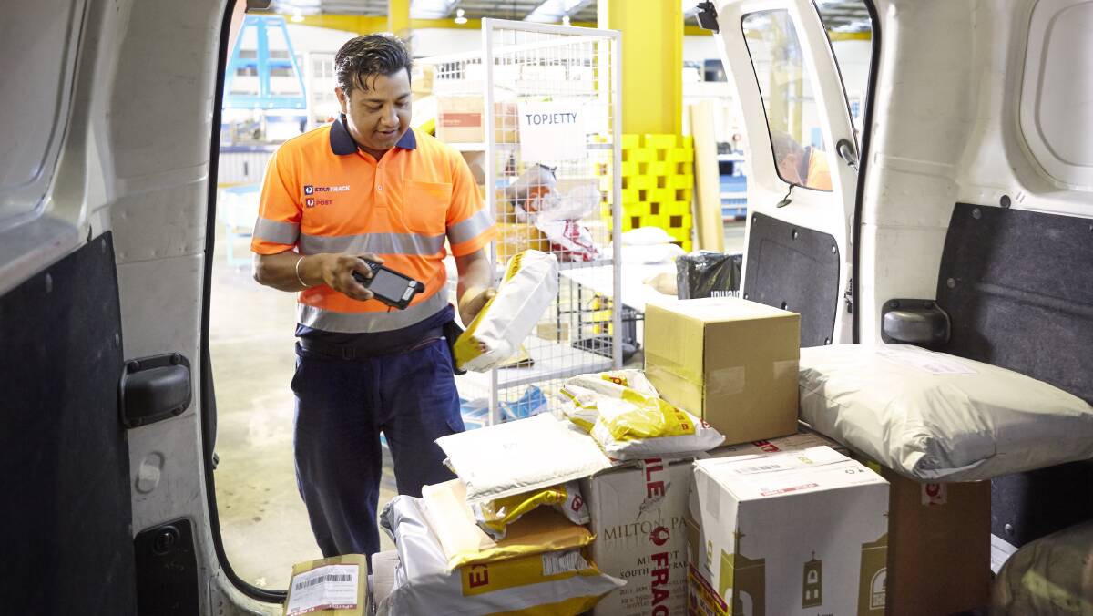 ON THE WAY: An Australia Post employee processes parcels. Picture: Supplied