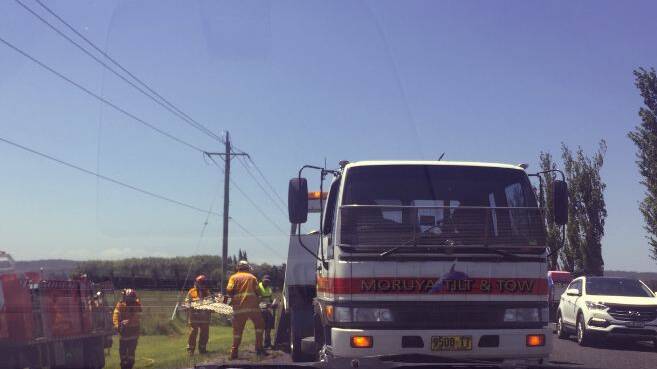 Emergency services work to free a victim from at the crash scene in Moruya.