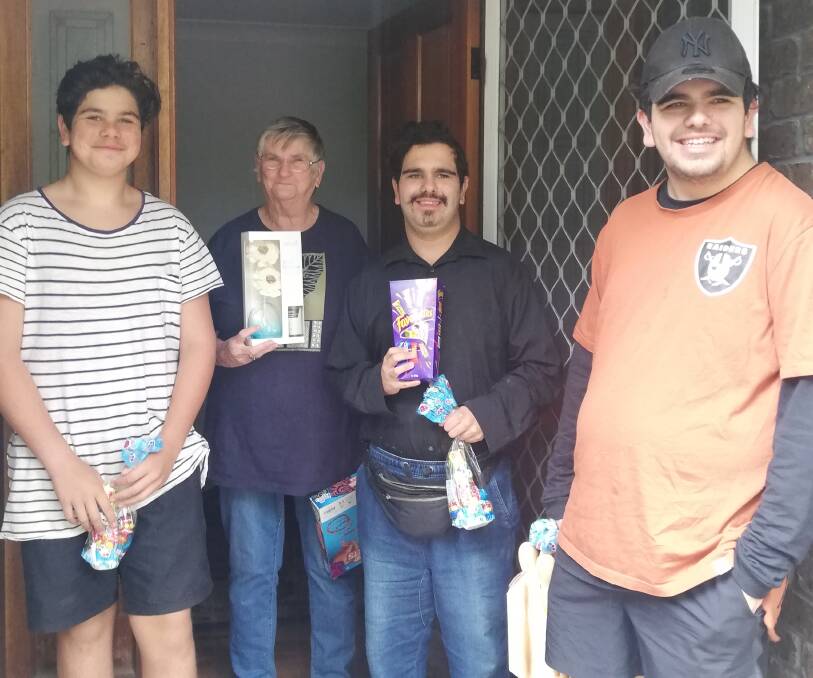 LIFE AFTER FIRE: Leroy Beer, Janette Glover, twins Ethan and Kyle Beer with gifts from the Clontarf Foundation's Moruya Academy, at their temporary South Rosedale home.