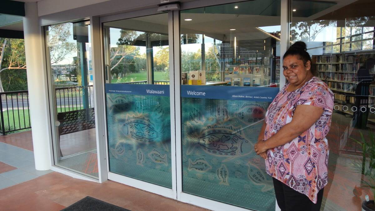 WELCOME: Allison Walker with a semi-transparent image of her work Birrima at the entry to the Moruya Library.