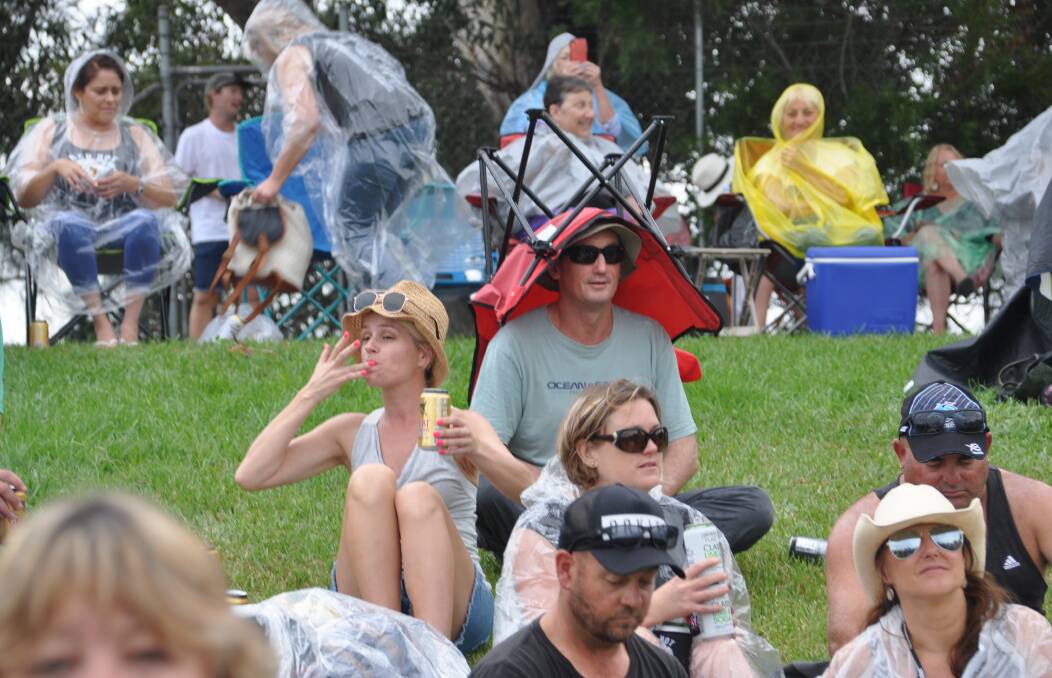 A man keeps himself dry at the Red Hot Summer Tour.
