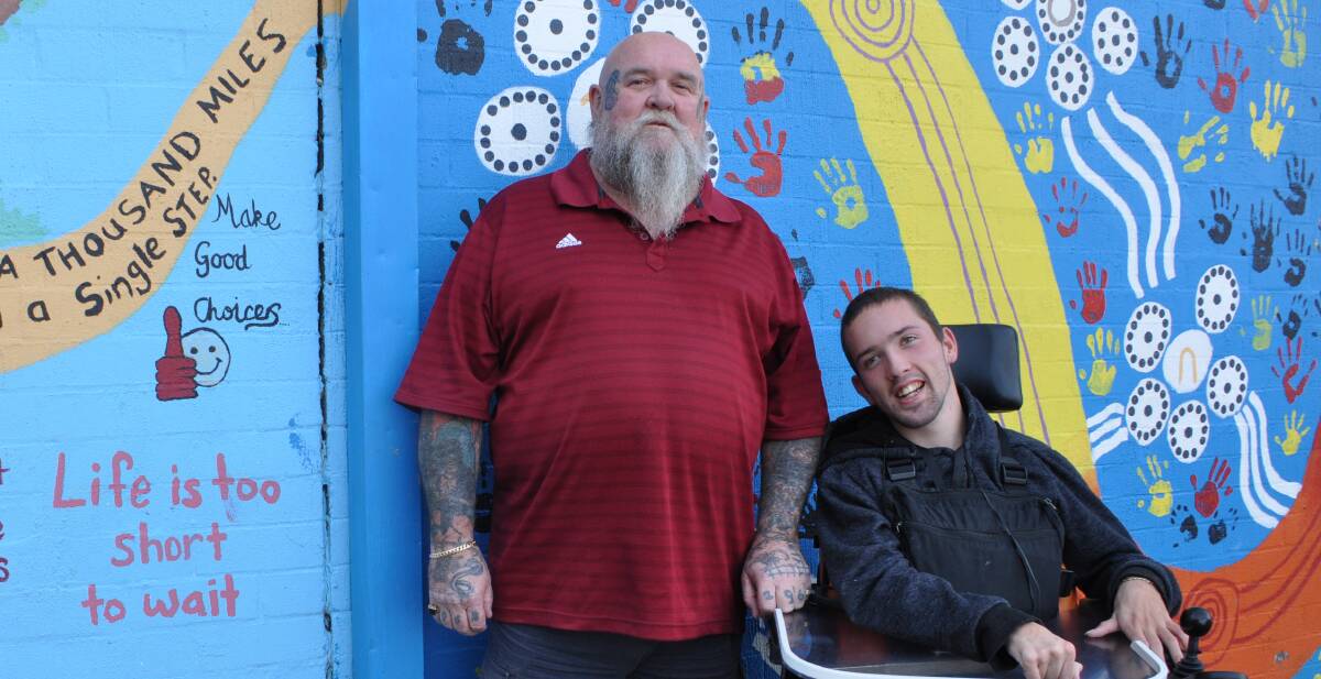 FATHER AND SON: Tyson Martin, with his father and primary carer David, hopes to raise $40,000 for a wheelchair-accessible van. 