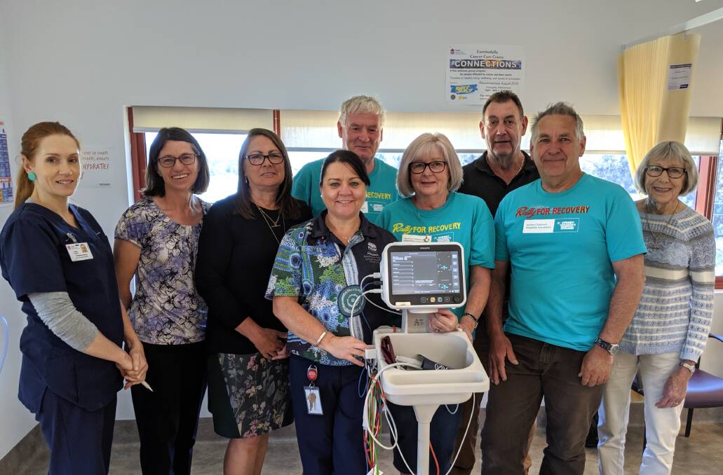 Registered Nurse Clare Waite, Nursing and Midwifery Director Leanne Ovington, Community Health Nurse Manager Edwina Fynmore, Cancer Centre Nurse Unit Manager Tracy Blake, Rally for Recovery committee members Sandra Sloan, Peter Fatches, Margaret Jarvis, (back) Ken Sloan and Michael Loftus. The group celebrates two new beds and a monitoring machine at the oncology ward at Moruya Hospital.