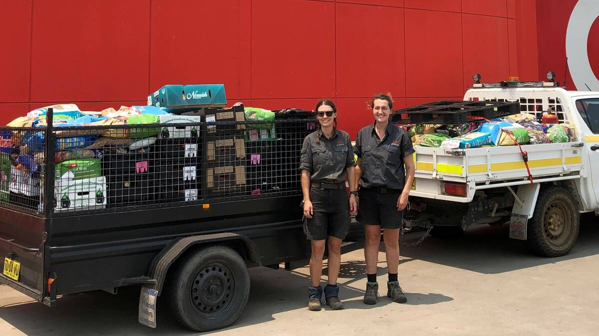 Mogo Wildlife Park zookeepers with Coles food donation. Photo: Coles