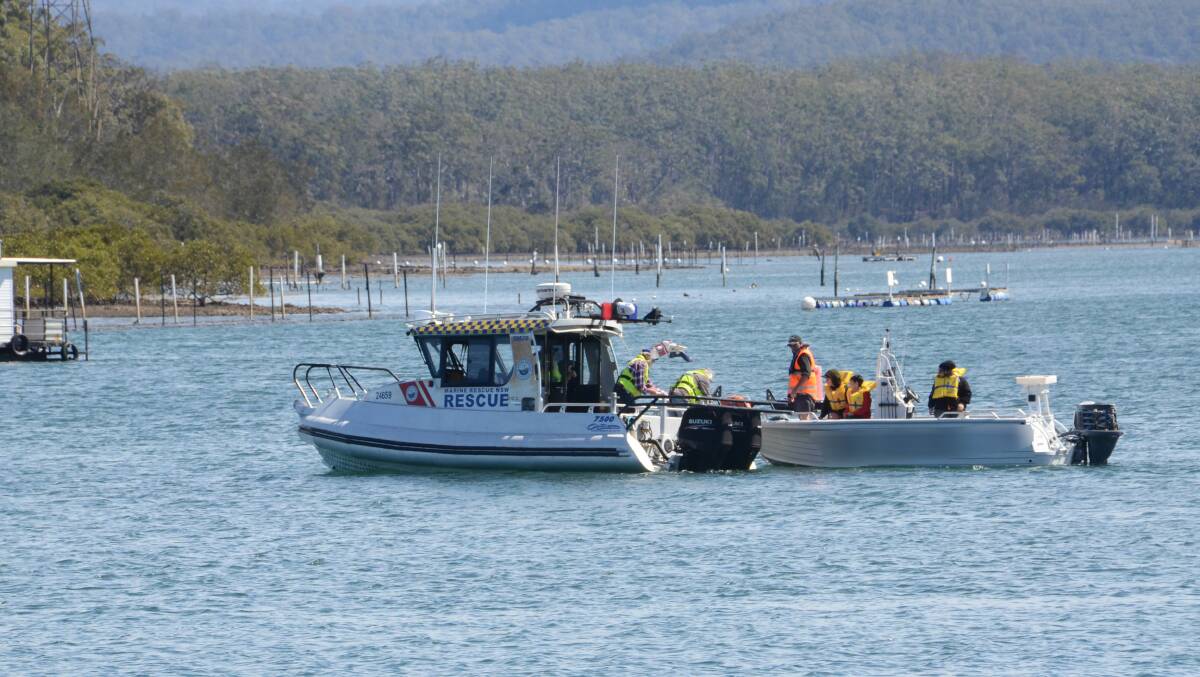 BLAZE ON WATER: Batemans Bay Marine Rescue tow a boat after it was on fire in the Clyde River, Batemans Bay. The fire was extinguished.