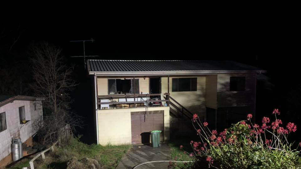 Firefighters smashed the window of an unoccupied Tuross Head house to extinguish the flames inside. Image: Moruya Fire and Rescue