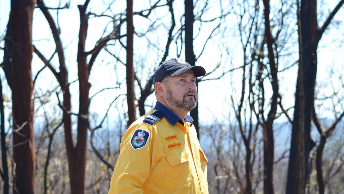 CHARRED: Batemans Bay RFS captain Ian Aitken assesses the regrowth of bush burnt by the New Year's Eve fire.