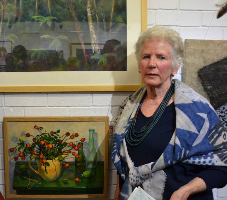 Janet Jones and her painting "Autumn Rosehips" won the $2000 River of Art Festival art prize.