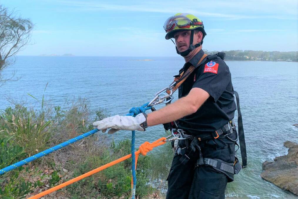 CLIFF RESCUE: Batemans Bay Fire and Rescue retained firefighter Ben Schutz harnesses up before saving a boy who slipped at Batehaven on Friday evening.