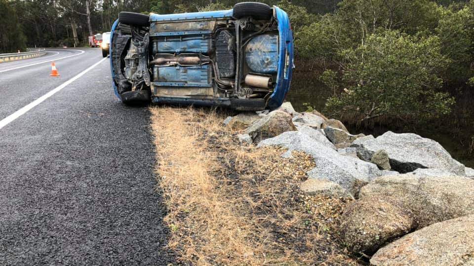 Moruya Fire and Rescue said a driver had a "very lucky escape" that car did not fall into Moruya River after overturning on North Head Drive. Picture: Moruya Fire and Rescue.