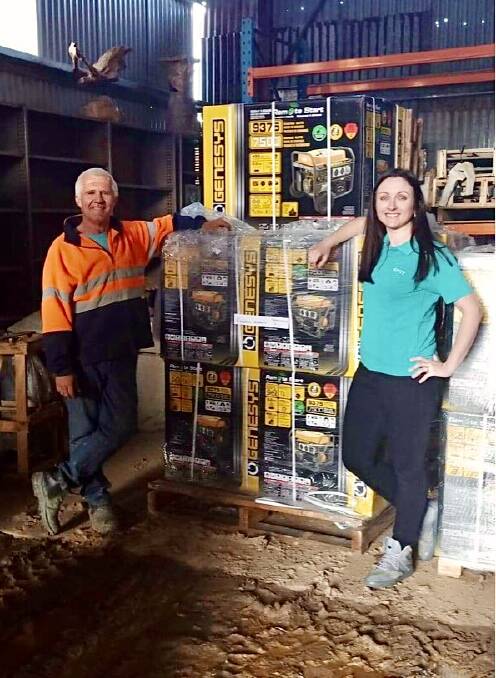 READY FOR ANYTHING: GIVIT NSW regional manager Caroline Odgers passes over 32 generators to Mogo Village Business Chamber president Richard Adams.