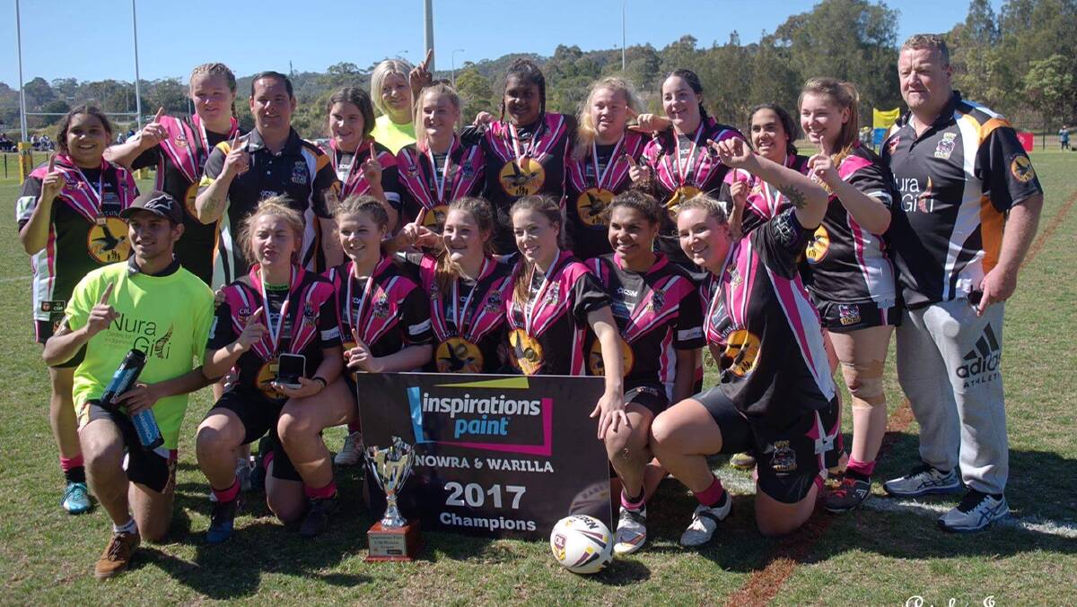 MAKING IT RAIN: The under 18s women's Tigers after the match, with manager Lorne Heron, Danielle Heron, supporter Kalem Davis-Wighton and the premiership trophy.