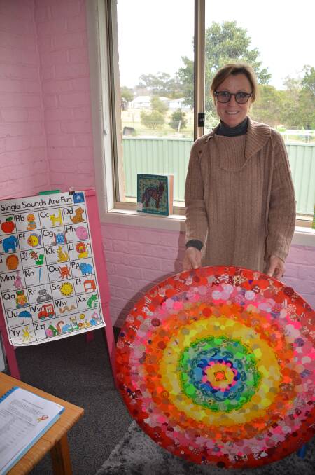 Cathi Young with a student artwork at Moruya Preschool.