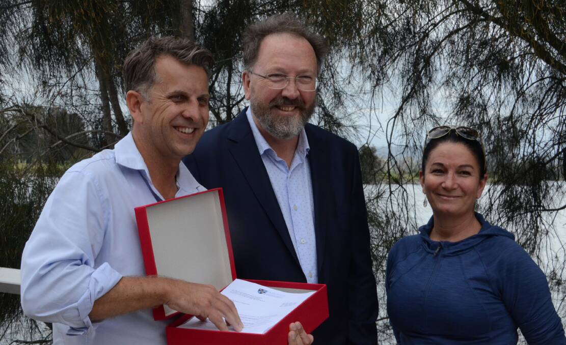 Bega MP Andrew Constance, Doctor Michael Holland and nurse Georgie Rowley when $150 million was announced in funding for a new regional Eurobodalla hospital. Mr Constance is holding a box containing petitions from shire residents in favour of a regional hospital.