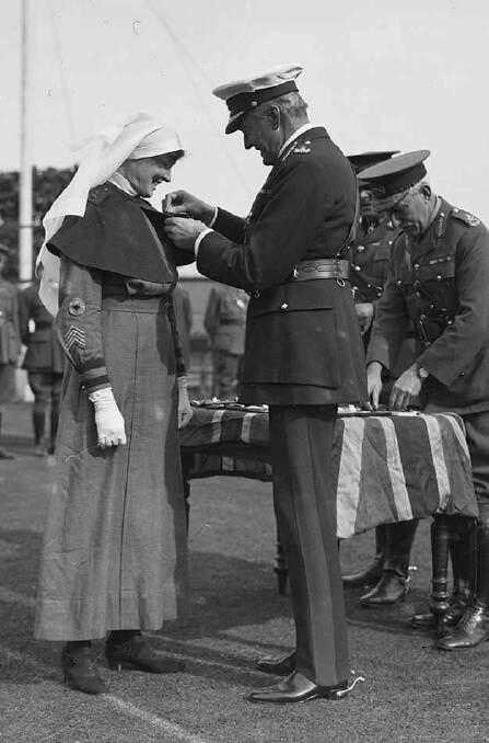 Sister Pearl Corkhill receiving her medal for 'courage and devotion'.