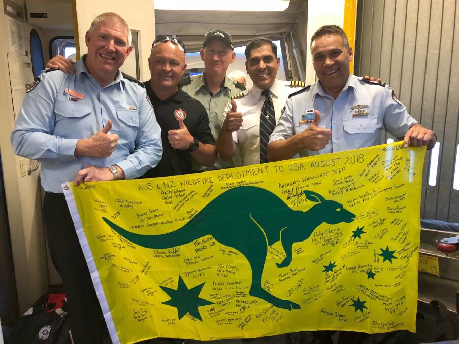 EUROBODALLA HERO: Phil Eberle (far left) stepping off the plane in the US to help fight wildfires in California.