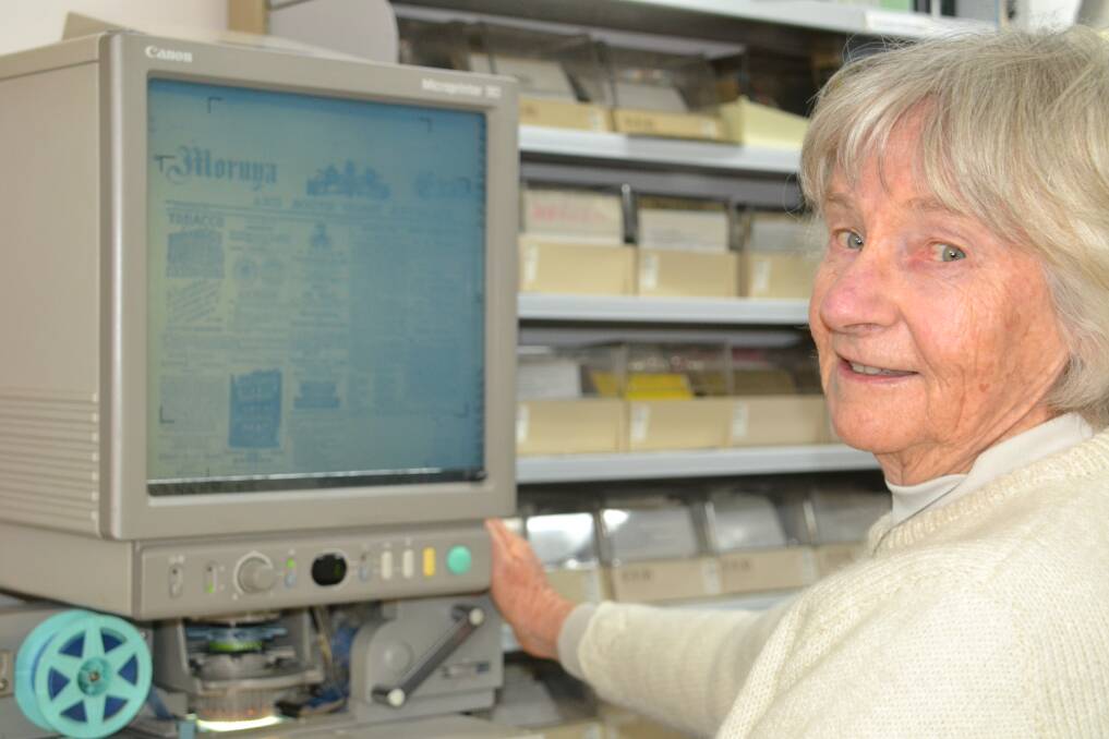 JOURNEY THROUGH TIME: Wendy Simes displays a microfiche of the Moruya Examiner from the 1800s.
