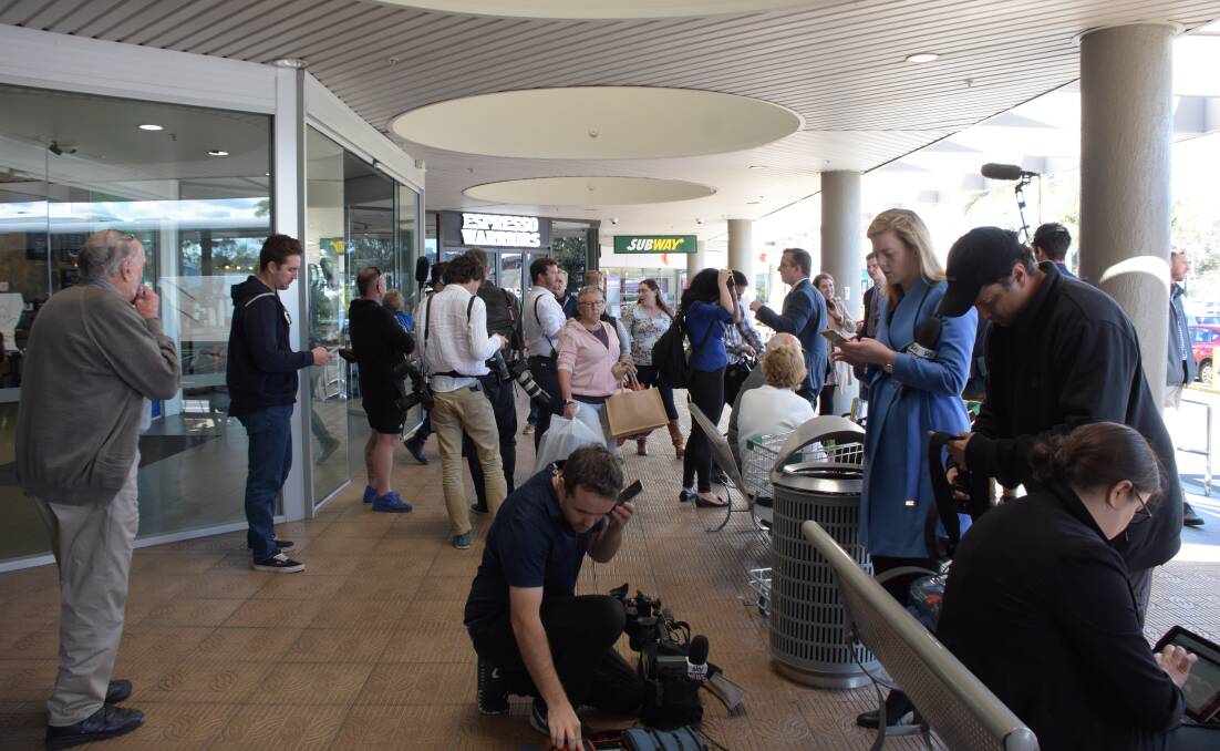 Spot the local - Stockland shoppers were surprised by the arrival of the media pack during the Labor leader's trip.