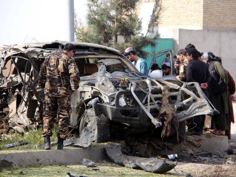 A top Afghan prosecutor and his bodyguard have been killed in a suicide car bombing.