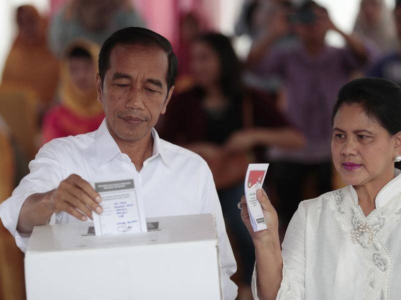 Indonesian President Joko Widodo and his wife Iriana cast their ballots in Jakarta.