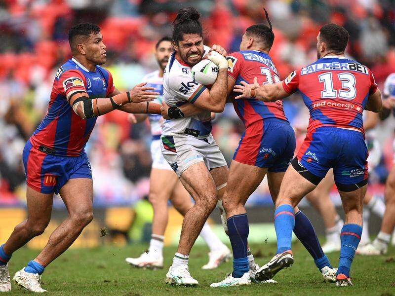 Gritty Newcastle overcame the Warriors in the wet to claim a second straight win. (Dan Himbrechts/AAP PHOTOS)
