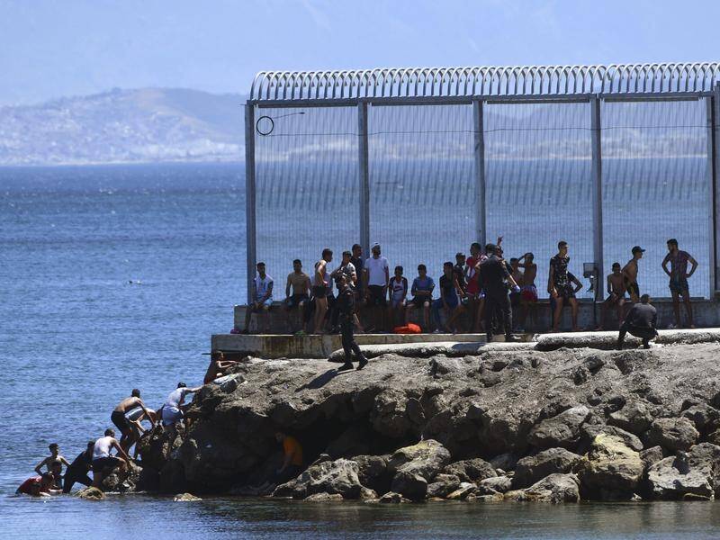 Spanish officers attempted to stop people from Morocco entering the Spanish territory of Ceuta.